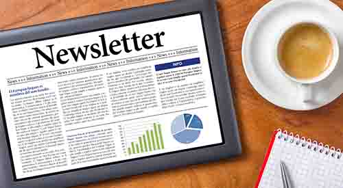 Tablet with newsletter on table